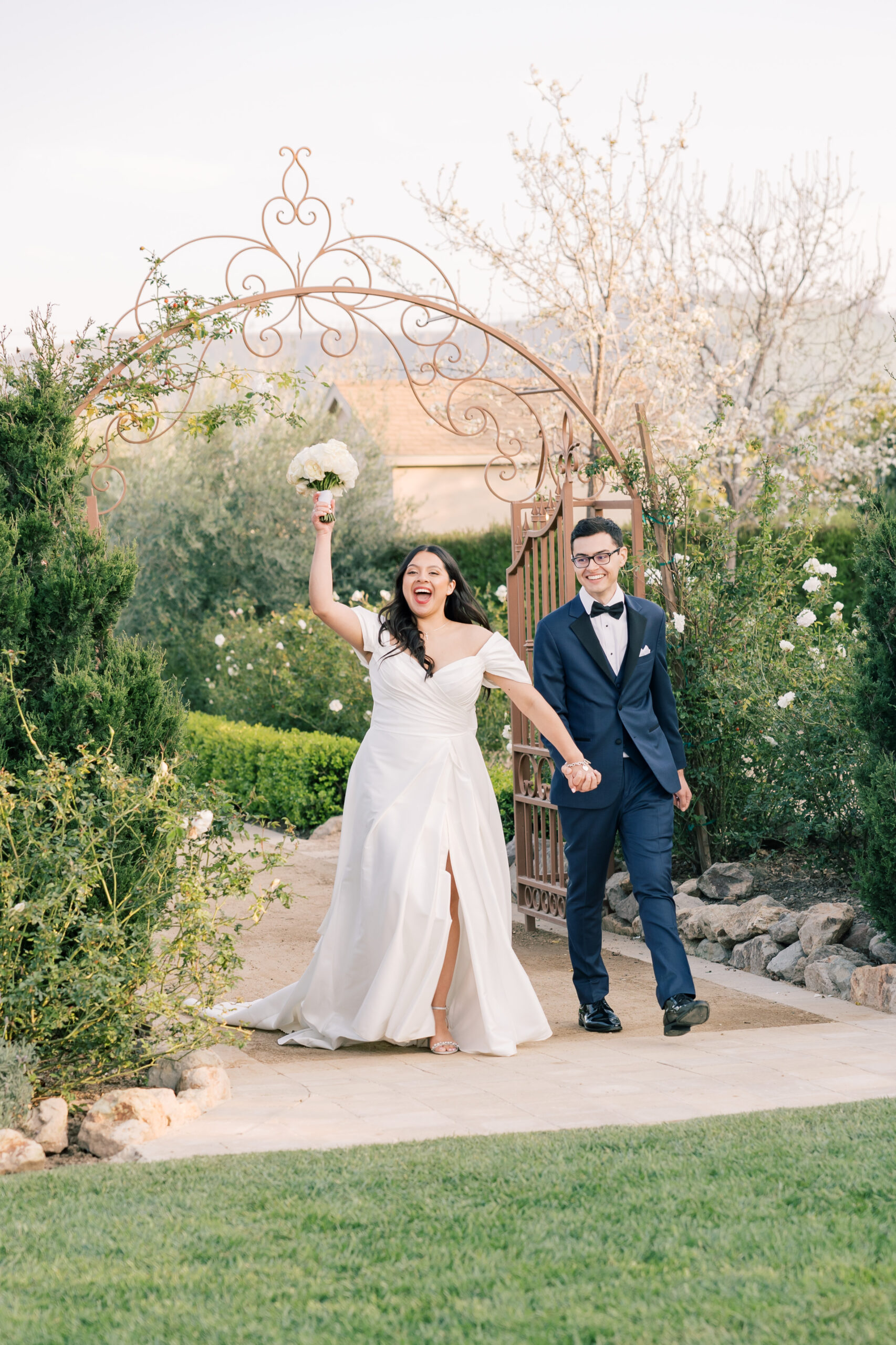 bride and groom walking into their reception at tuscan rose ranch