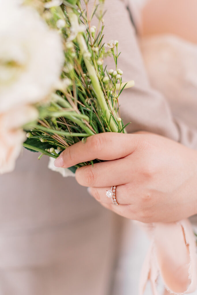 close up of bride's engagement and wedding ring