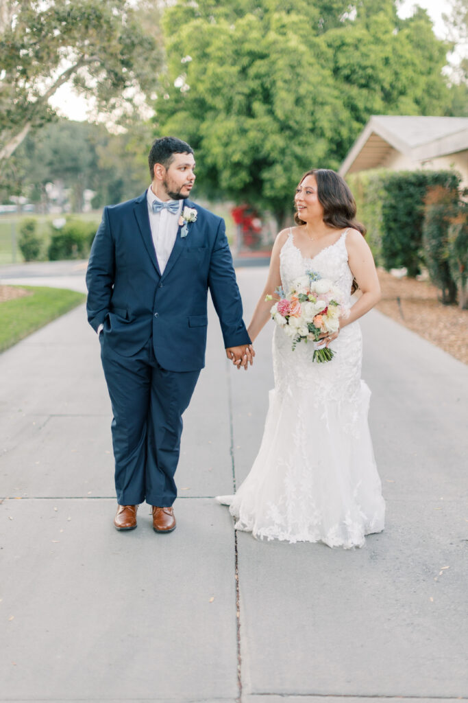 bride and groom holding hands at knollwood country club