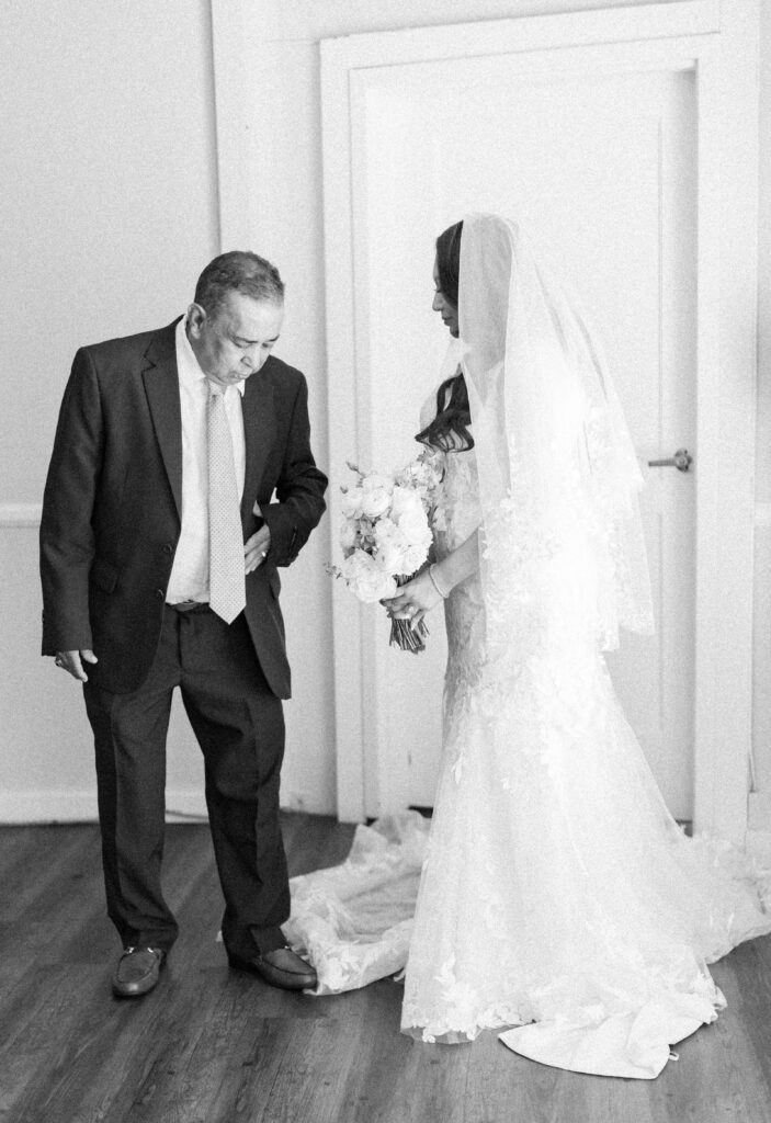man admiring his daughter in her wedding dress