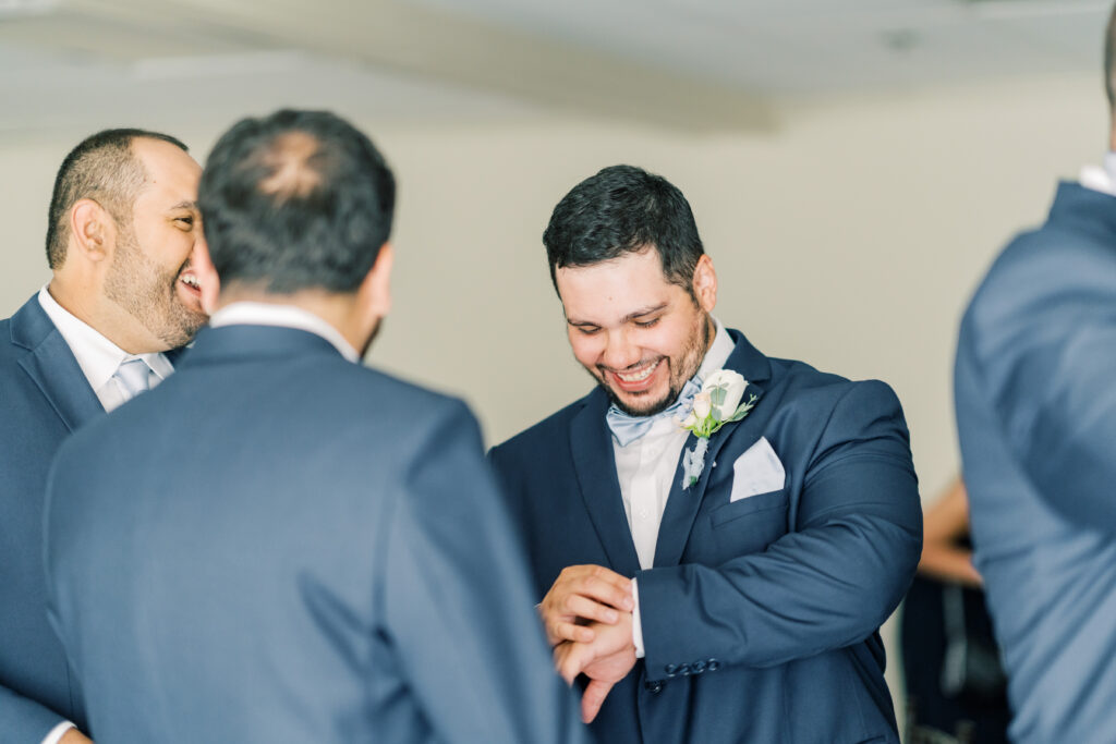 groom laughing with his groomsmen