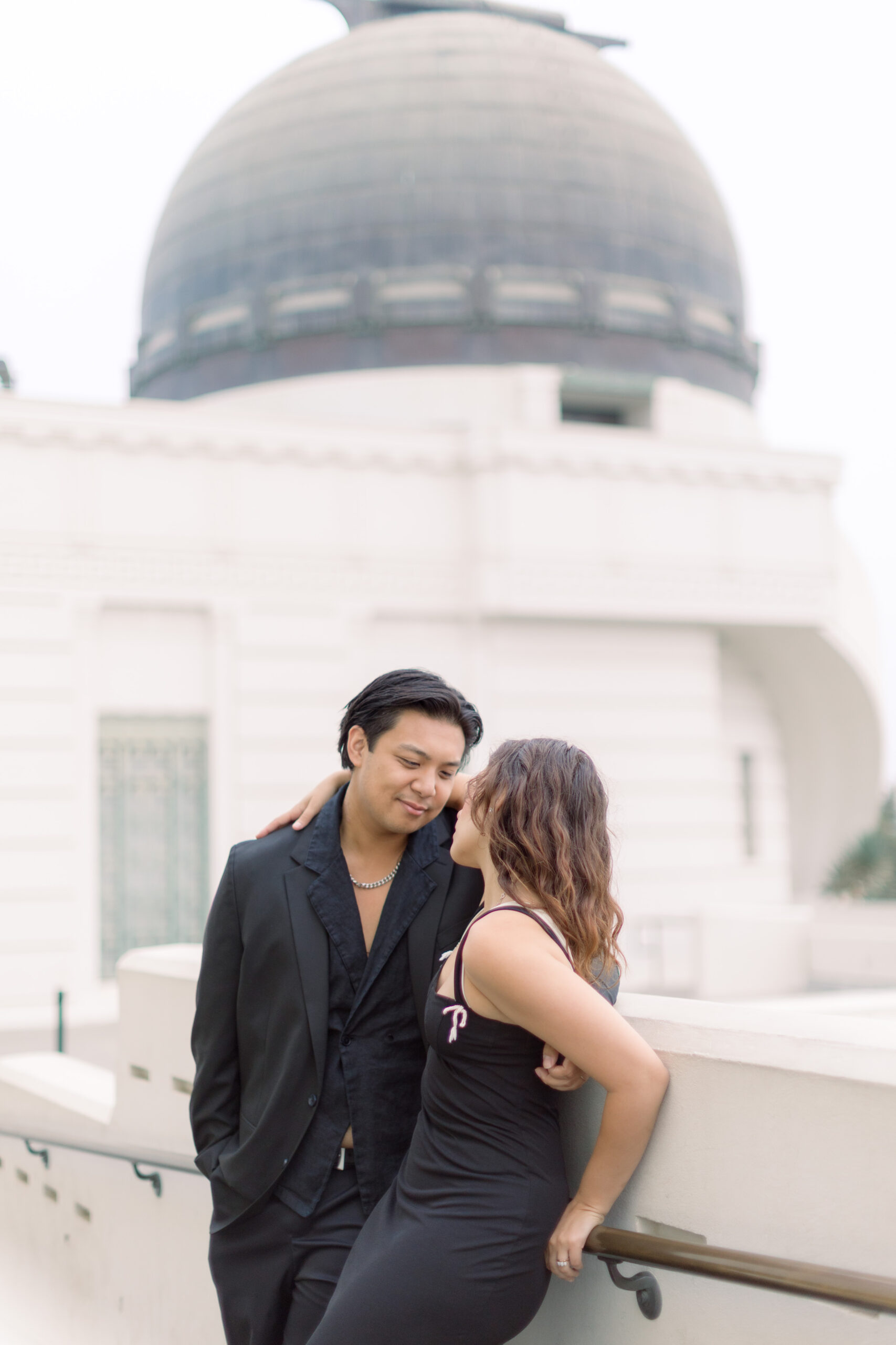 woman staring into her boyfriend's eye in behind the Griffith Observatory