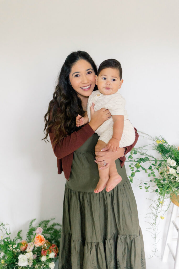 Mother holding her infant facing the camera. Izabel Cortez Photo, Los Angeles and Ventura County Wedding Photographer